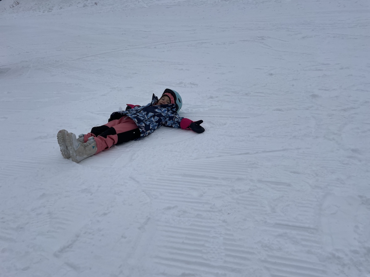 A child lays on the snow