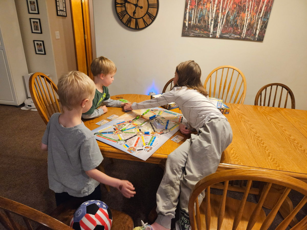 Best indoor active play gifts horizontal 10 Three kids playing ticket to ride first journey on a kitchen table