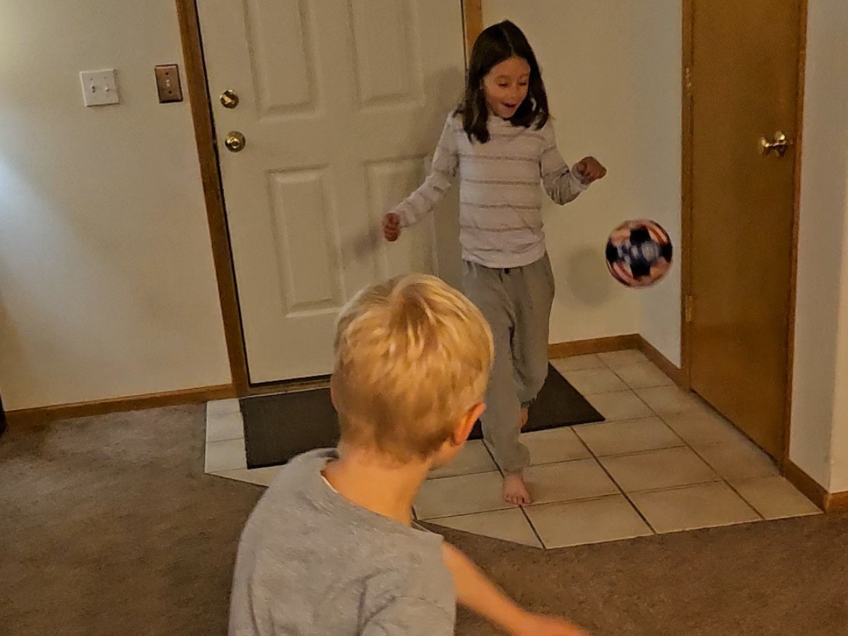 Best indoor active play gifts horizontal 11 Boy kicking an indoor soccer ball to girl.