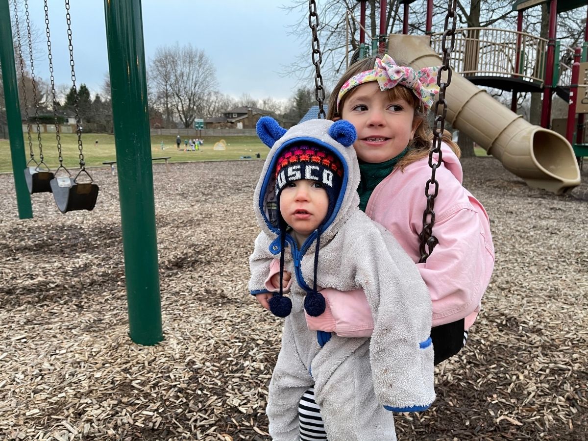 kids playing at a playground in winter