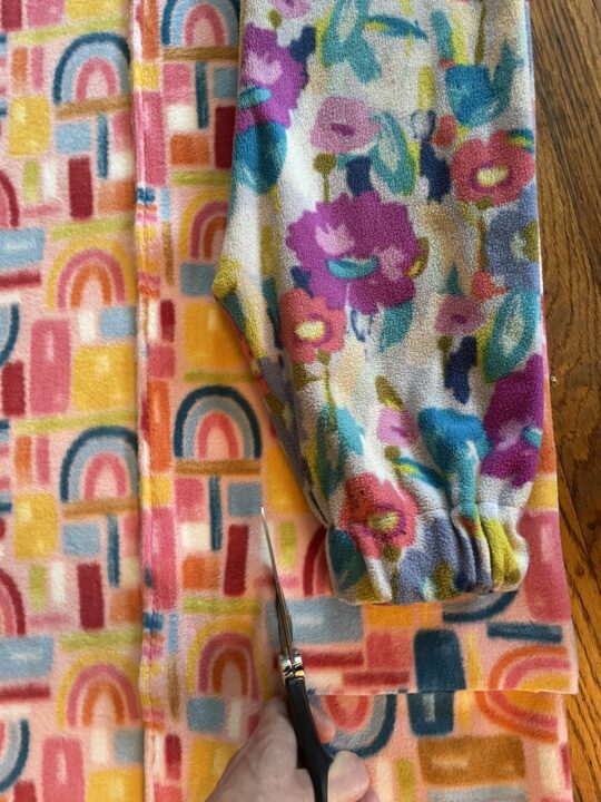 cutting one leg at a time with the sample pants on top as a gauge