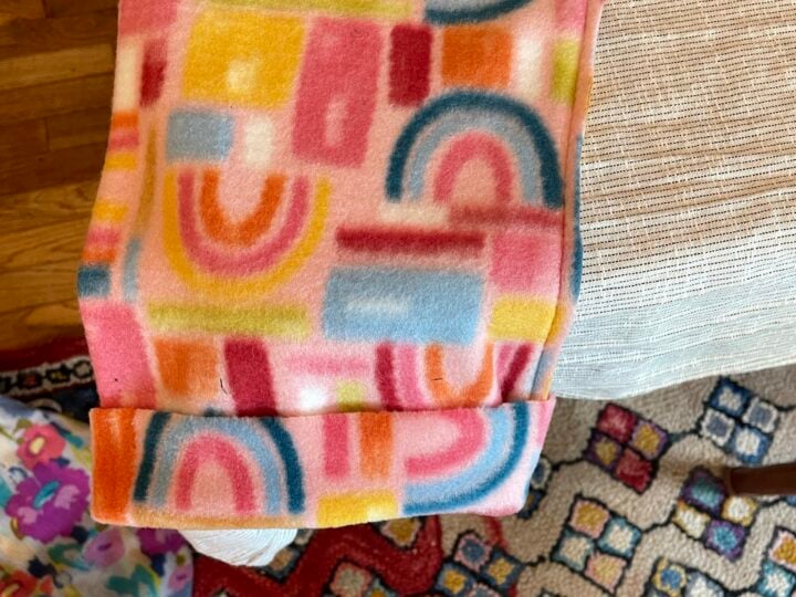 Pants are inside out and hem is folded up 2 inches showing right side.