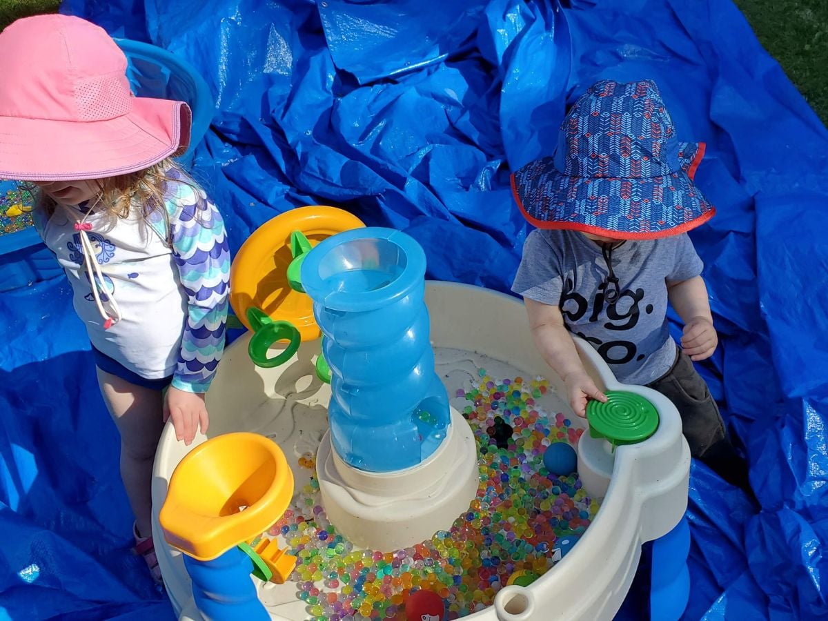 Easter Baskets for Outdoor Kids - Horizontal 8 Two kids playing with water beads in a water table