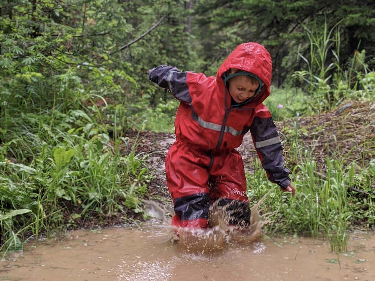 bestraingearforkids3 boy splashing in a muddy puddle