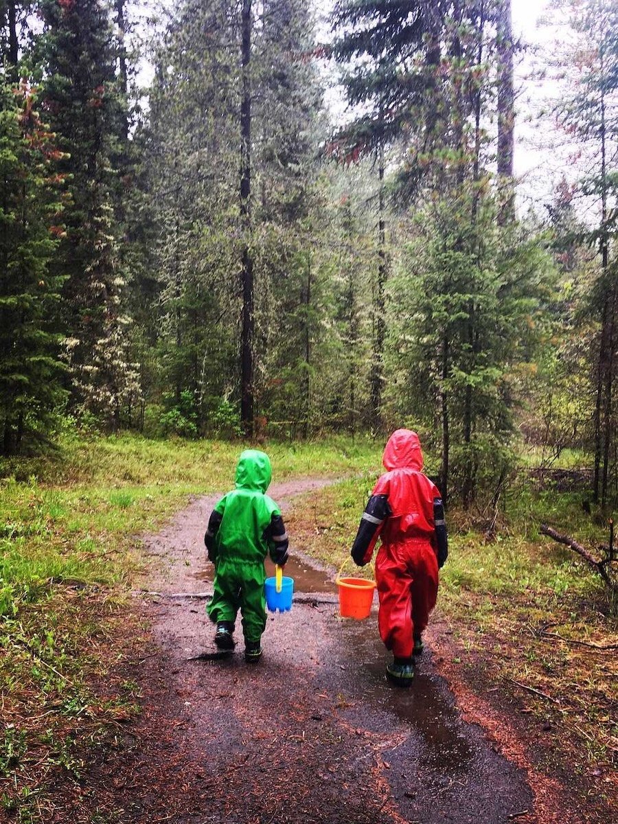 bestraingearforkids7 two kids walking on a wet forest path