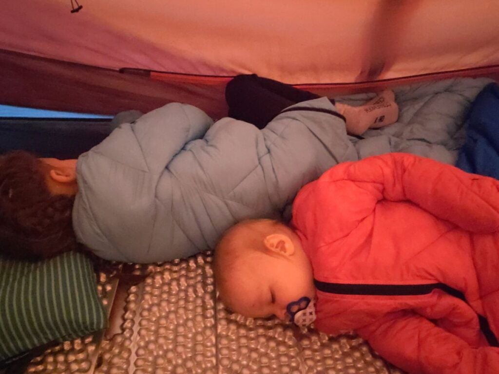 Two kids sleeping in the Marmot limelight 2 person tent on foam sleeping pad in morrison outdoor sleeping bags