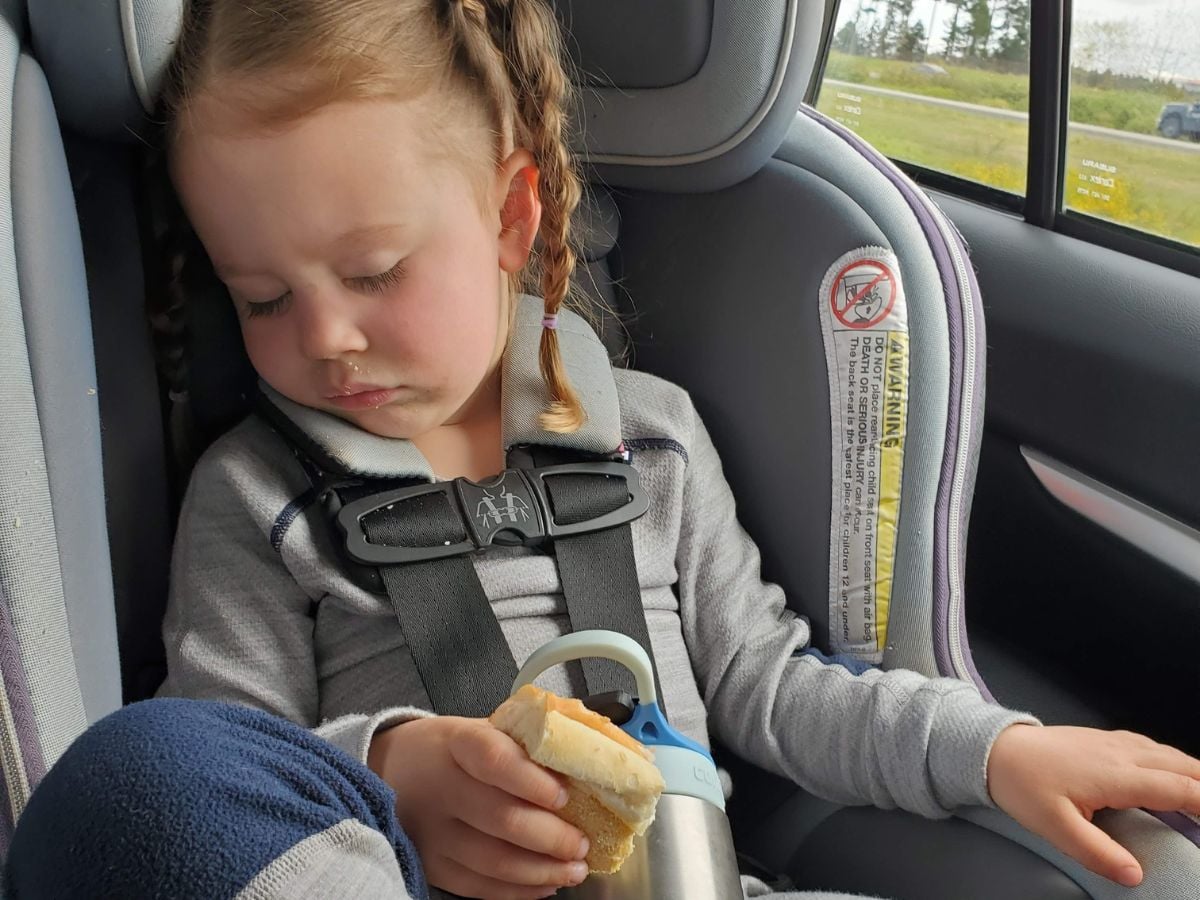 Best Base layers for kids Horizontal -3 Girl wearing Helly Hansen base layers while asleep in the carseat
