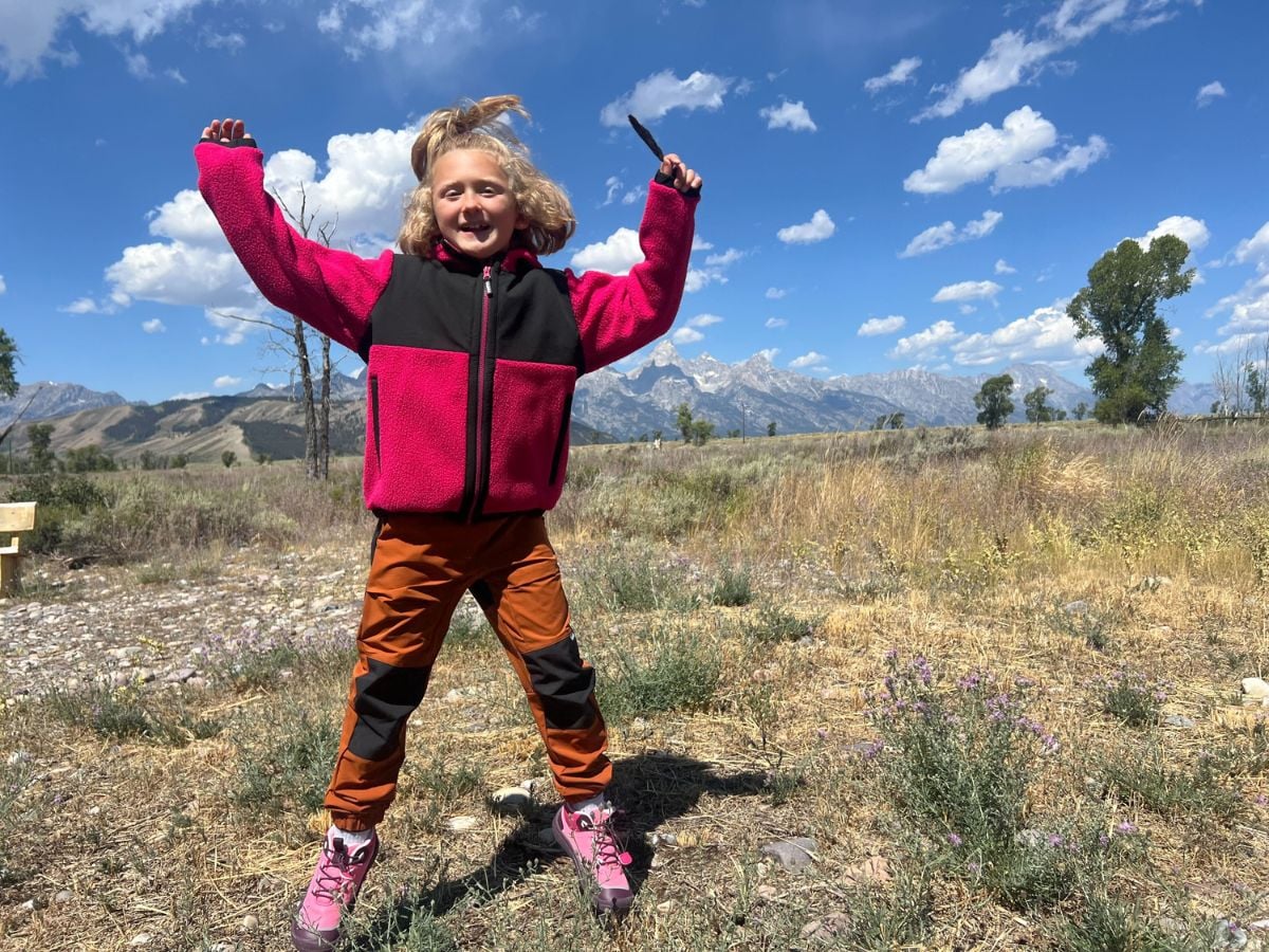 Back to School Gear 9 A girl jumping outdoors wearing Reima gear
