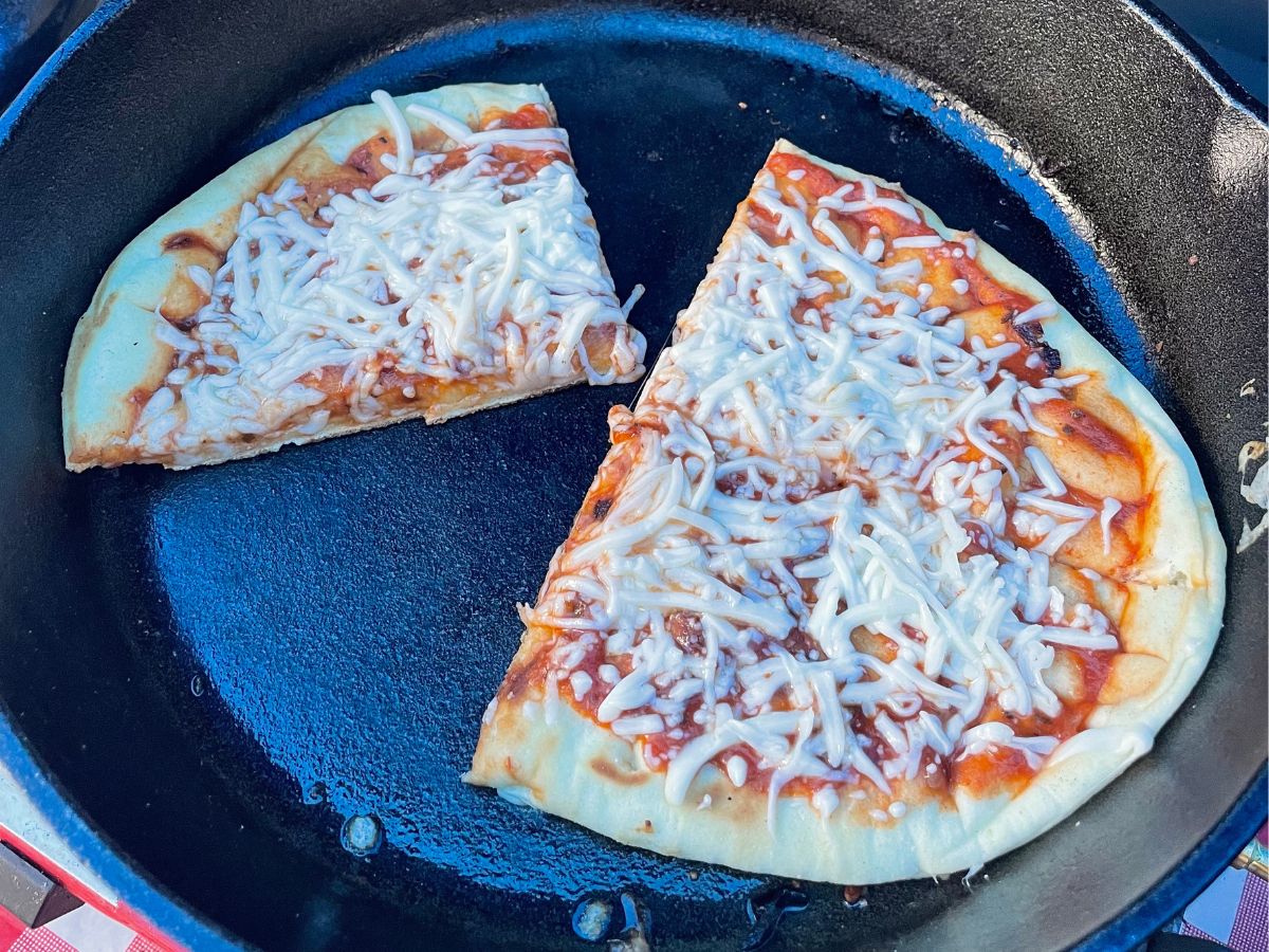Image of a cast iron cheese pizza in a cast iron pan