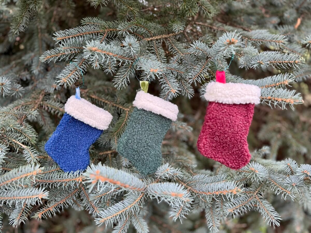 Three small stockings hang on a tree
