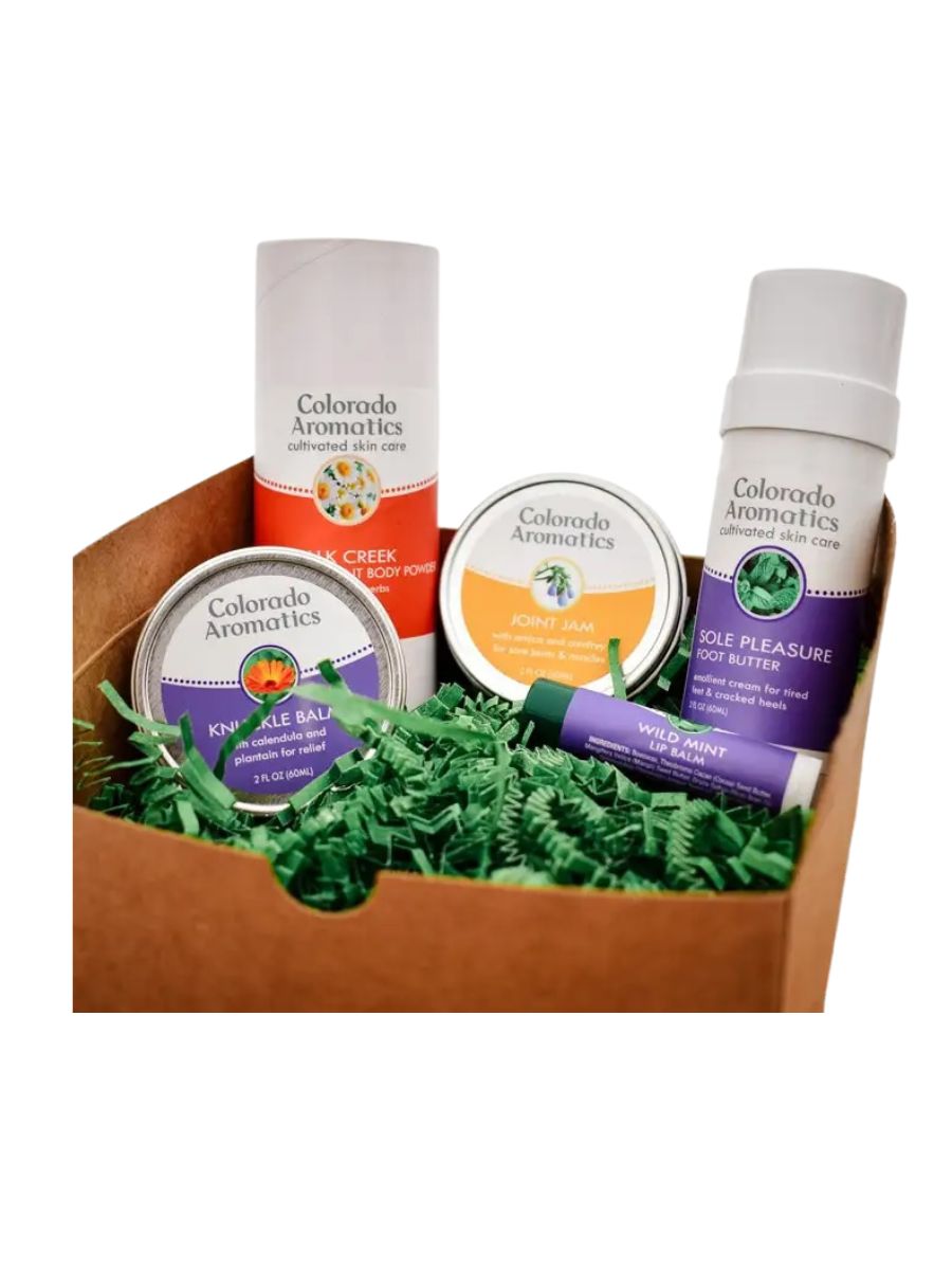 A stock image of some balms and tins and chapstick in a gift basket