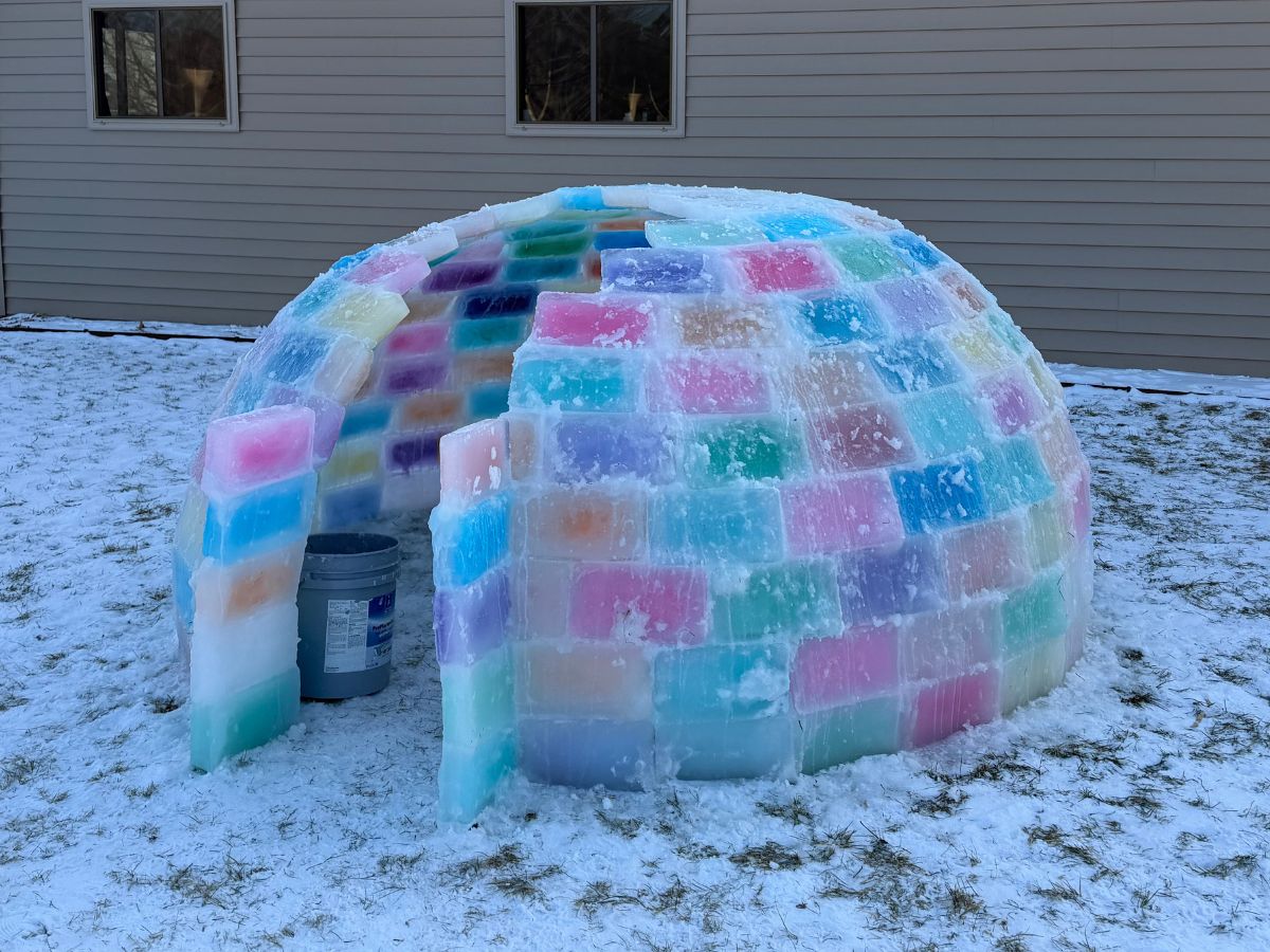 BuildanIceIgloo (12) A colored ice block igloo is almost complete, just a small gap left to close on the roof.