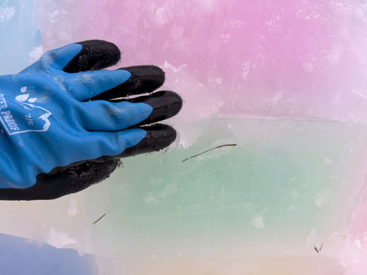 BuildanIceIgloo (3) A hand with slush patches a hole in the ice block igloo.