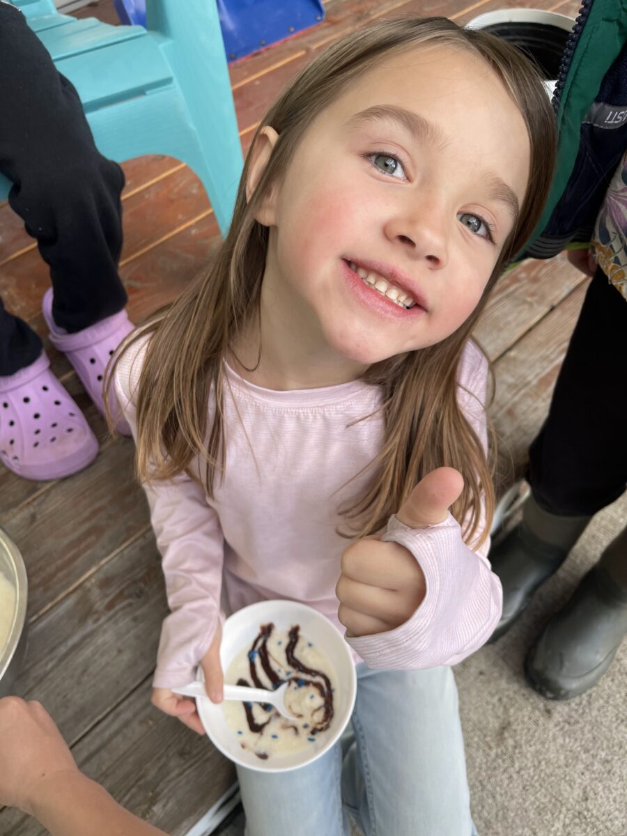 A young girl eating snow ice cream.