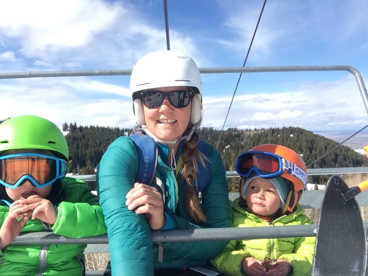 SkiFood4 Two toddlers eat on the ski chairlift with their mom.