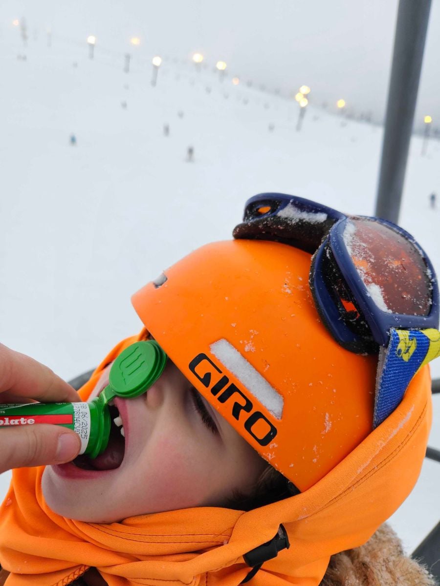 SkiFood6 A child eats mini M&Ms on a chairlift.