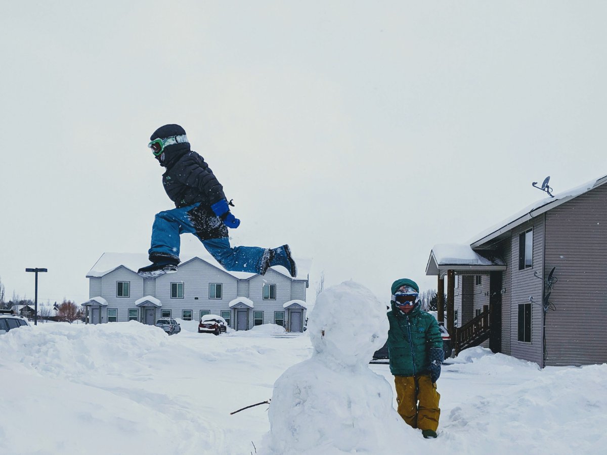 TMM and KRB Horizontal and Featured (37) Kids dressed in snow clothes jumping off a snowman.