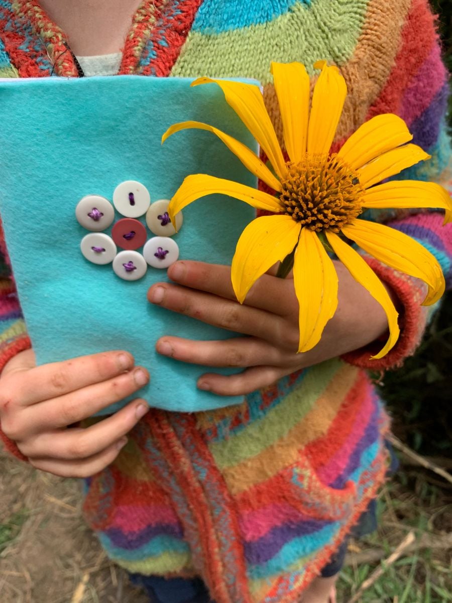 CitizenScienceforKids5 Child holding notebook and flower
