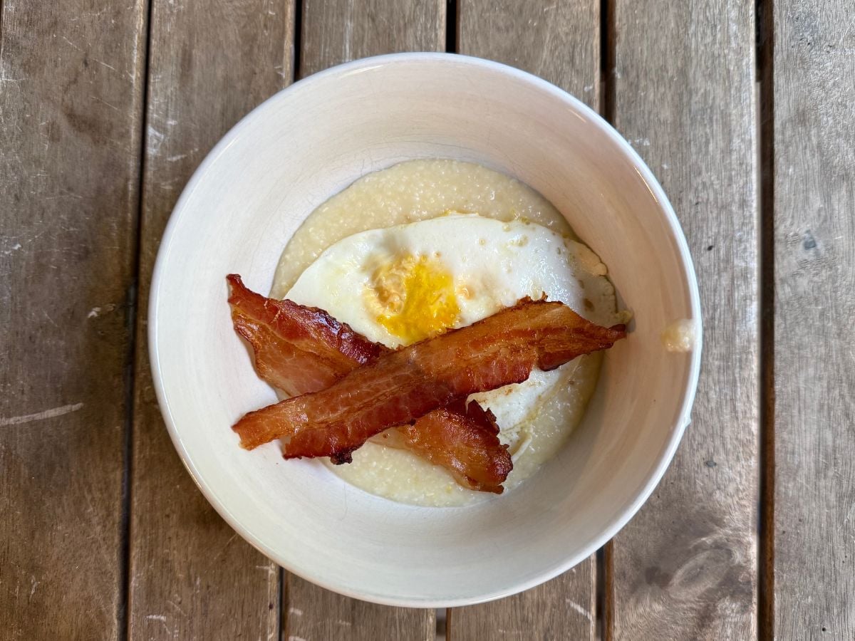 GF Meal Plan 4 Image of two pieces of bacon and an egg on top of grits in a white bowl