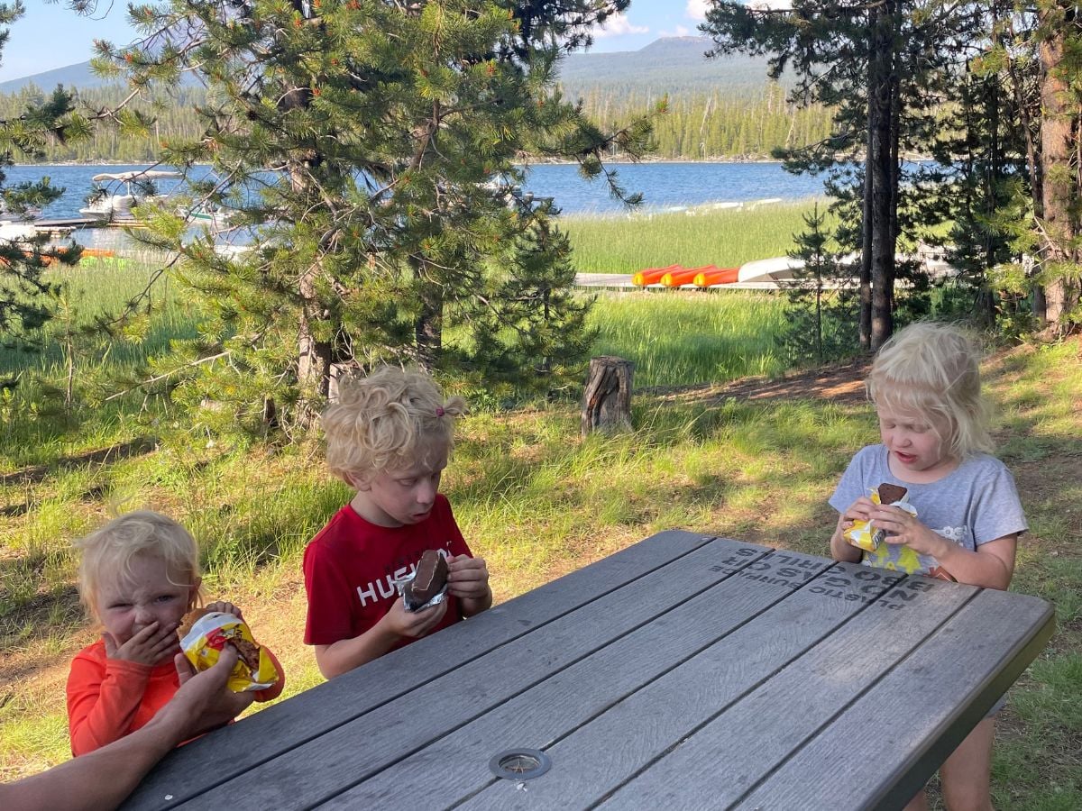 GF Meal Plan 7 Three kids eating ice cream bars at a picnic table by a lake