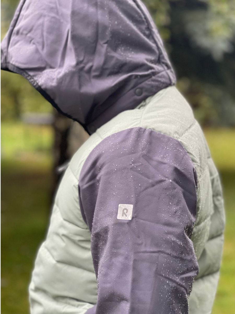 The Reima hybrid jacket repelling water.